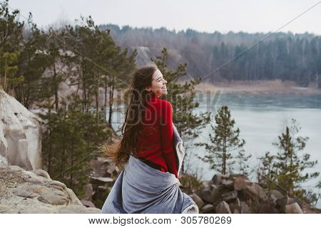 Young Beautiful Girl Posing On A Background Of Lake