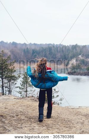 Young Beautiful Girl Posing On A Background Of Lake