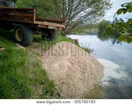 Tractor Trailer Tipping A Load Of Sand To Create Beach