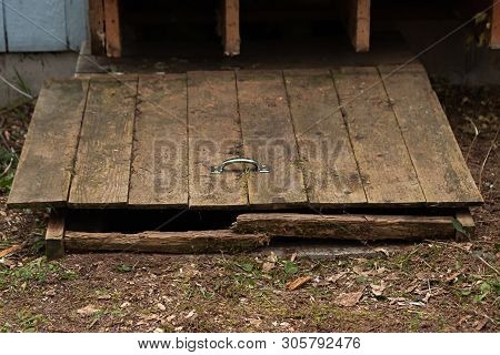 Old Wooden Hatch To Crawlspace Damaged And Worn