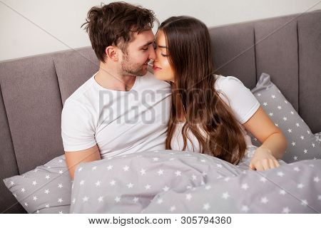 Happy Couple Having Fun In Bed. Intimate Sensual Young Couple In Bedroom Enjoying Each Other