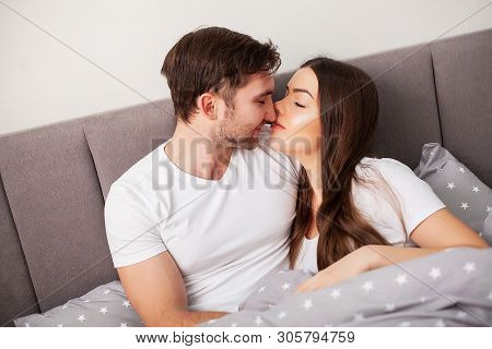 Happy Couple Having Fun In Bed. Intimate Sensual Young Couple In Bedroom Enjoying Each Other
