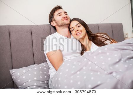 Happy Couple Having Fun In Bed. Intimate Sensual Young Couple In Bedroom Enjoying Each Other