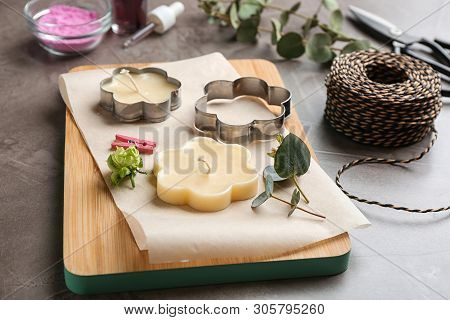 Handmade Candles With Cutters On Stone Background