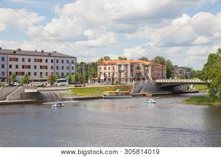 City Jelgava, Latvian Republic. River Lielupe, Peoples And Urban City View. Houses And Walking Paths