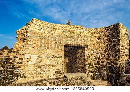 Old Stone Wall Remains Of Muttrah Fort Under A Blue Sky In The Evening. From Muscat, Oman.