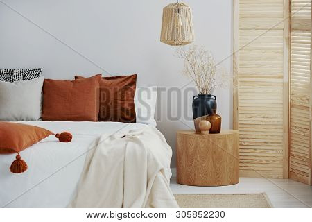 Dark Orange And Grey Pillow On King Size Bed, Copy Space On Empty Wall