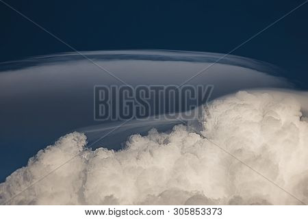 Rare Lenticular Cloud Altocumulus Lenticularis On Top Of A Cumulus Cloud In Front Of A Blue Sky