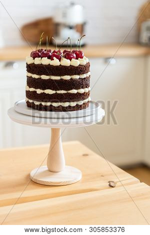Summer Dessert With Cherries. Naked Chocolate Cake On The Kitchen Table. Holiday Concept. Happy Birt