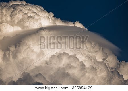 Rare Lenticular Cloud Altocumulus Lenticularis On Top Of A Cumulus Cloud In Front Of A Blue Sky