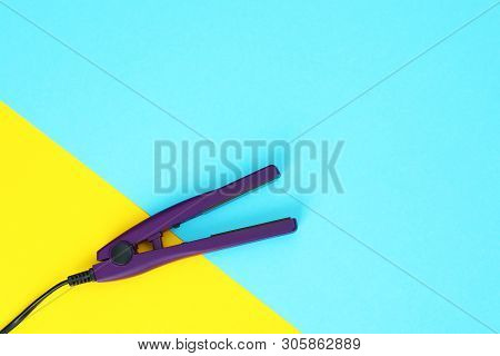 Modern Hair Iron For Straightening On Color Background, Top View With Space For Text