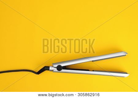 Modern Hair Iron For Straightening On Color Background, Top View With Space For Text