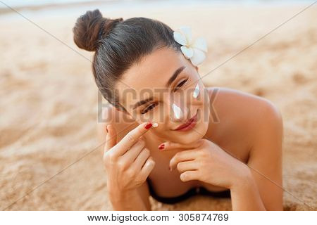 Beautiful Woman Face Portrait Beauty Skin Care Concept. Suncream. Suntan Lotion Beautiful Woman Appl