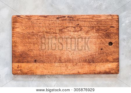 Old Chopping Board On Grey Concrete Background, Copy Space For Your Text