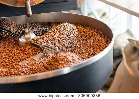 Freshly Roasted Coffee Beans From A Large Roaster In The Cooling Cylinder. Motion Blur On The Beans,