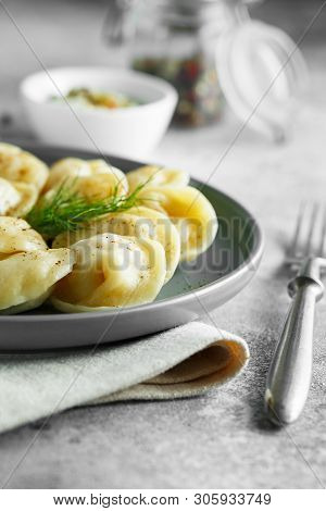 Meat Dumplings - Russian Pelmeni, Ravioli With Meat On A Grey Plate.