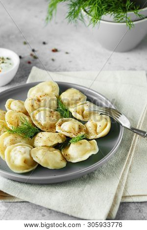 Meat Dumplings - Russian Pelmeni, Ravioli With Meat On A Gray Plate.