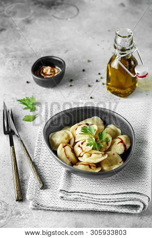 Meat Dumplings - Russian Pelmeni, Ravioli With Meat On A Grey Bowl.