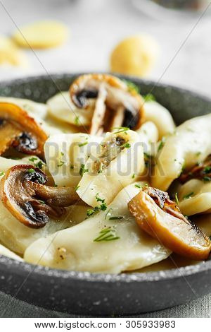 Dumplings, Filled With Mashed Potatoes And Mushrooms On Little Frying Pan. Russian, Ukrainian Or Pol