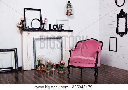 Vintage Velar Armchair, In A Bright Room And An Artificial Fireplace. Interior Attic With Wooden Whi