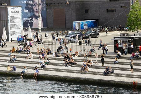 Copenhagen, Denmark 06/02/2019 People Enjoying Summer Warm Weather On The Larsen Plads Street In The