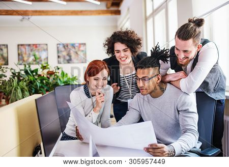 Group Of Young Businesspeople Working In Office, Start-up Concept.
