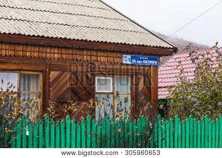 Esso, Kamchatka Peninsula, Russia- 02 October 2014: Green Fence In Front Of Small Wooden House. Smal