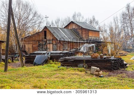 Esso, Kamchatka Peninsula, Russia- 02 October 2014: Wooden Farm Building, Boards And Logs For Firewo