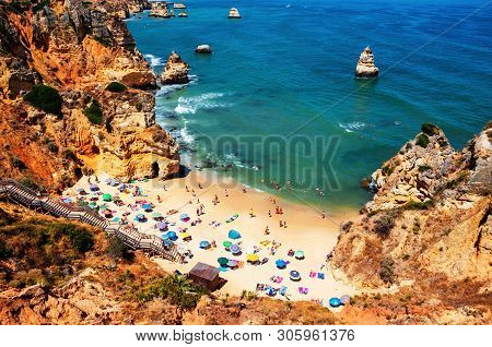 Aerial View Of Crowded Camilo Beach In Lagos, Algrave, Portugal During The Sunny Day