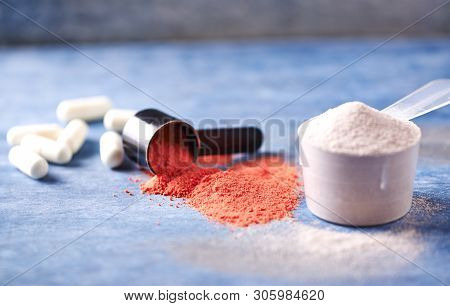 Scoop Of Whey Protein, Creatine Powder And Taurine Capsules. Sport Nutrition. Rustic Wooden Backgrou