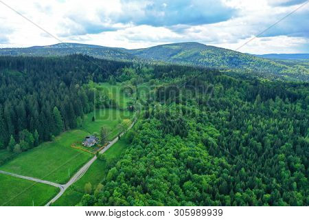 Aerial Perspective View On Sudety Mountains During Cloudy Day With Villages In The Valley Surrounded