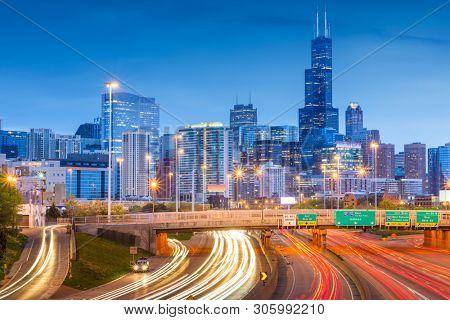 Chicago, Illinois, USA downtown skyline over highways at twilight. 