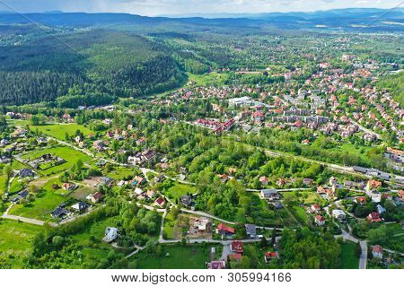 Aerial Perspective View On Sudety Mountains With Touristic City In The Valley Surrounded By Meadows,