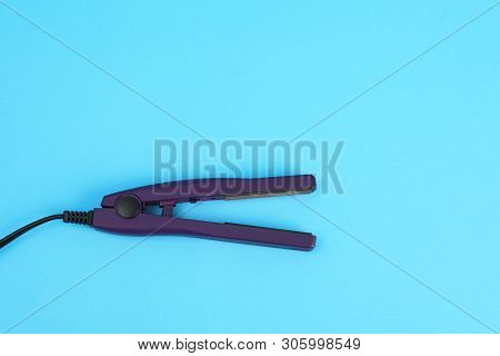 Modern Hair Iron For Straightening On Color Background, Top View