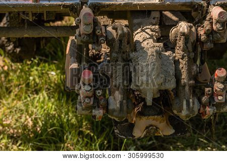 Close Up Of Mechanical Fingers Of Rice Planting Machine Caked With Mud.