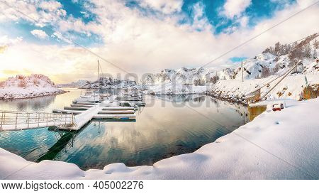 Charming Winter Scenery With Yachts And Boats Nier Pier In Small Fishing Village And Snowy  Mountain