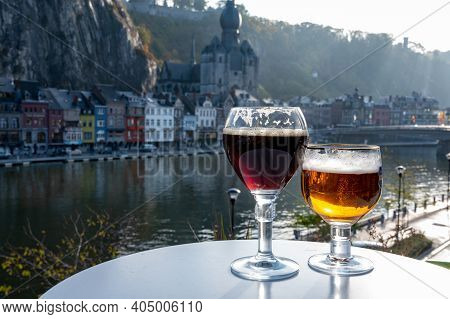 Drinking Of Dark And Strong Belgian Abbey Beer With Cheeses With Nice View On Maas River And Town Di