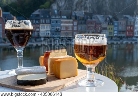 Drinking Of Dark And Strong Belgian Abbey Beer With Cheeses With Nice View On Maas River And Town Di