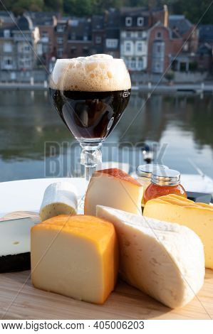 Glass Of Belgian Abbey Beer And Tasting Of Cheeses Made With Trappist Beer And Fine Herbs With View