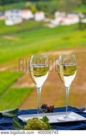 Tasting Of French Sparkling White Wine With Bubbles Champagne On Outdoor Terrace With View On Green 
