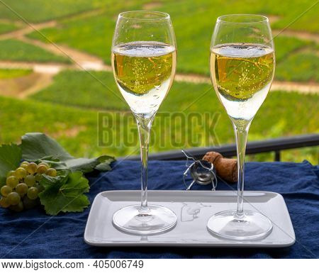 Tasting Of French Sparkling White Wine With Bubbles Champagne On Outdoor Terrace With View On Green 