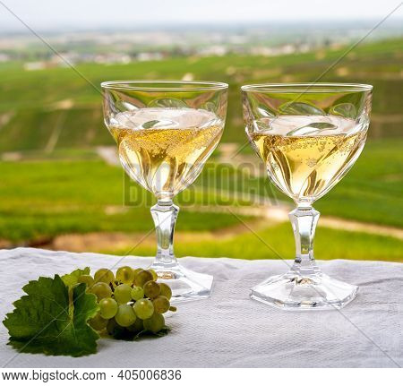Tasting Of French Sparkling White Wine With Bubbles Champagne On Outdoor Terrace With View On Green 