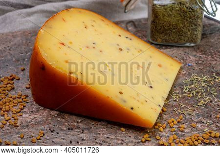 Cheese Collection, Piece Of Hard Yellow Dutch Gouda Cheese With Dried Caraway, Mustard, Cumin, Peppe