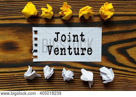 Business And Finance Concept. On A Wooden Board Lie Crumpled Leaves Of Paper And A Sheet From A Note