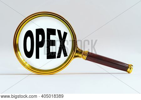 Finance And Economics Concept. Magnifier On A White Background, Inside The Text Is Written - Opex