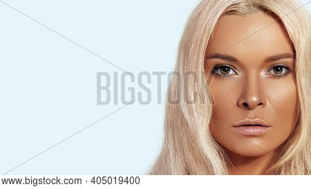 Sexy Model With Fashion Make-up, Clean Skin, Blond Hair On Blue Background. Elegant Girl With Shiny