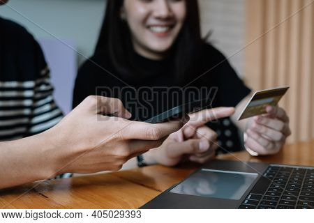 Happy Couple Shopping Online With Smartphone Laptopn And Creditcard At Home