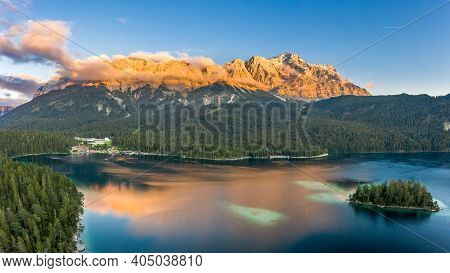 Aerial Drone Shot Of Alpenglow With Fog On Zugspitze By Eibsee Lake In Germany
