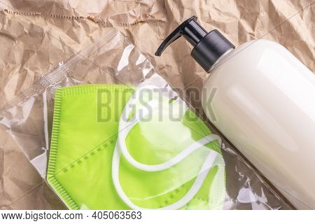 Respiratory Mask Kn95 And A Plastic Bottle With An Alcoholic Hand Sanitizer. Medical Protective Trav