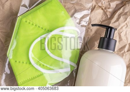 Disinfecting Gel And A New Medical Respiratory Mask Kn 95 In A Pack On Wrinkled Kraft Paper Packagin